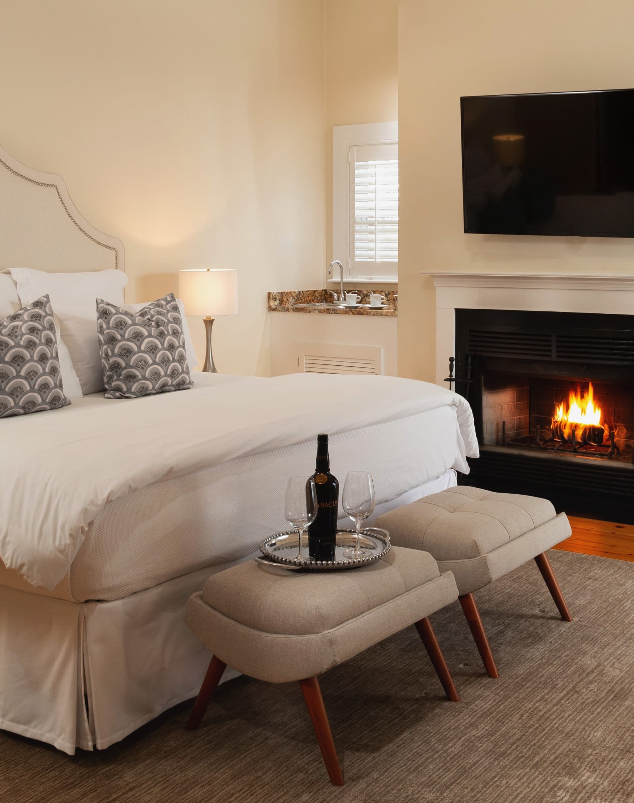 Hotel room with wine bottle and glasses on seats at the Chatham
