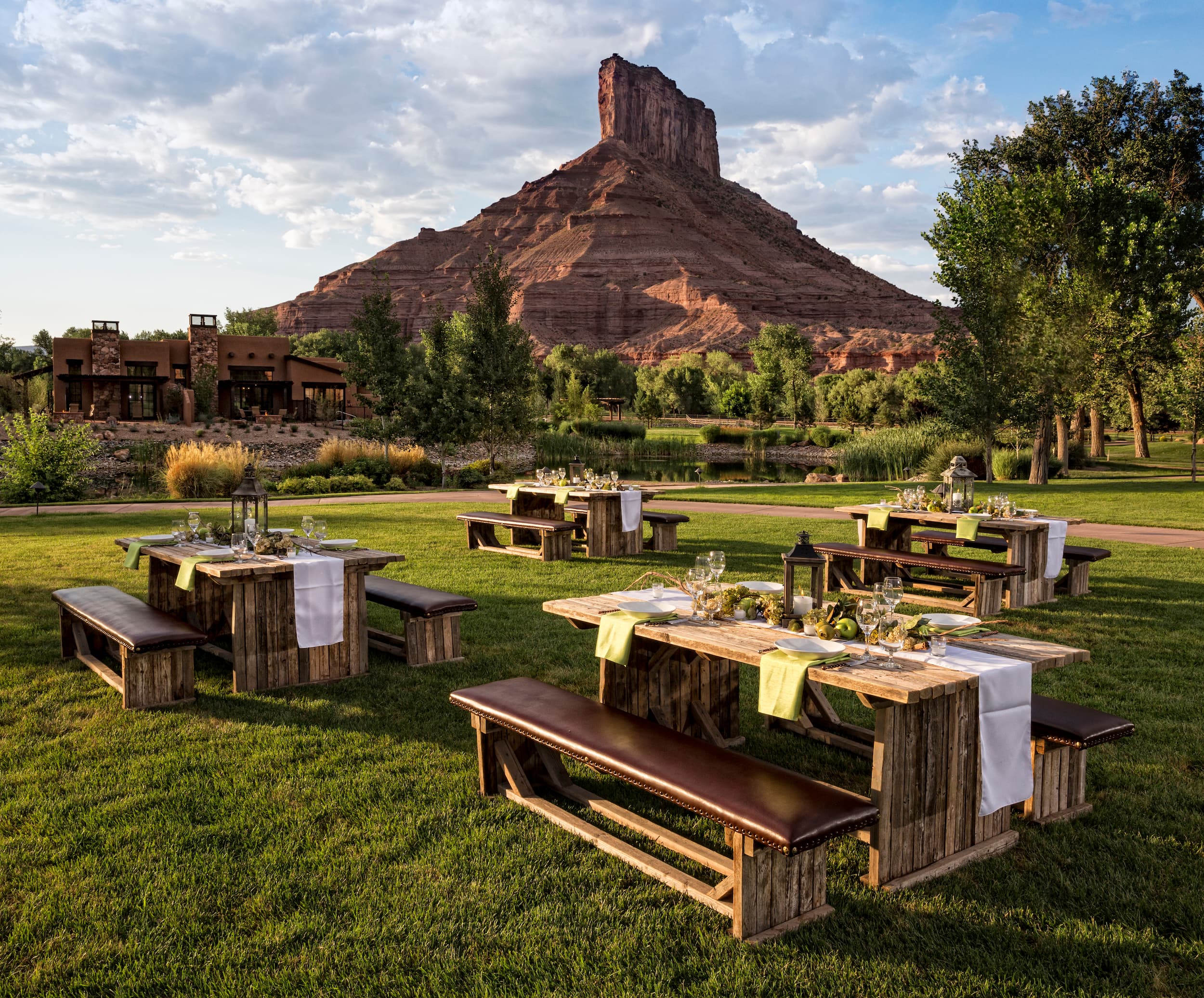 4 picnic tables set up for an outdoor event with Parriott Mesa in the background at Gateway Canyons Resort & Spa, Colorado