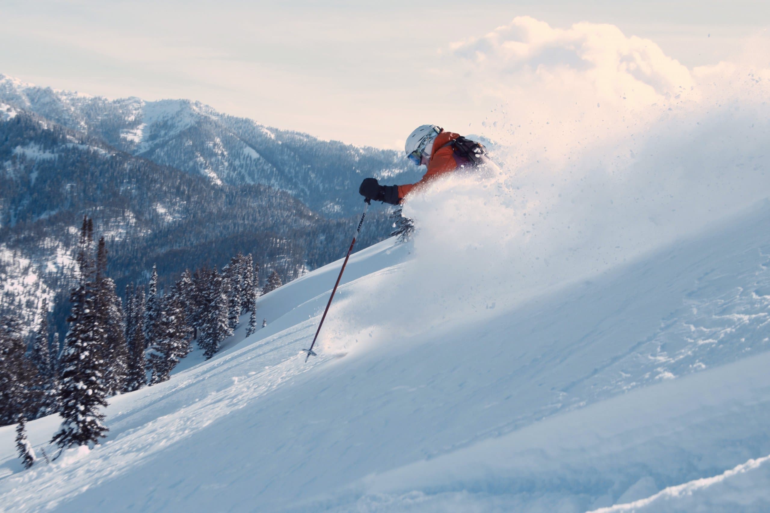 Person skiing down a ski slope at a Noble House Hotels & Resorts property