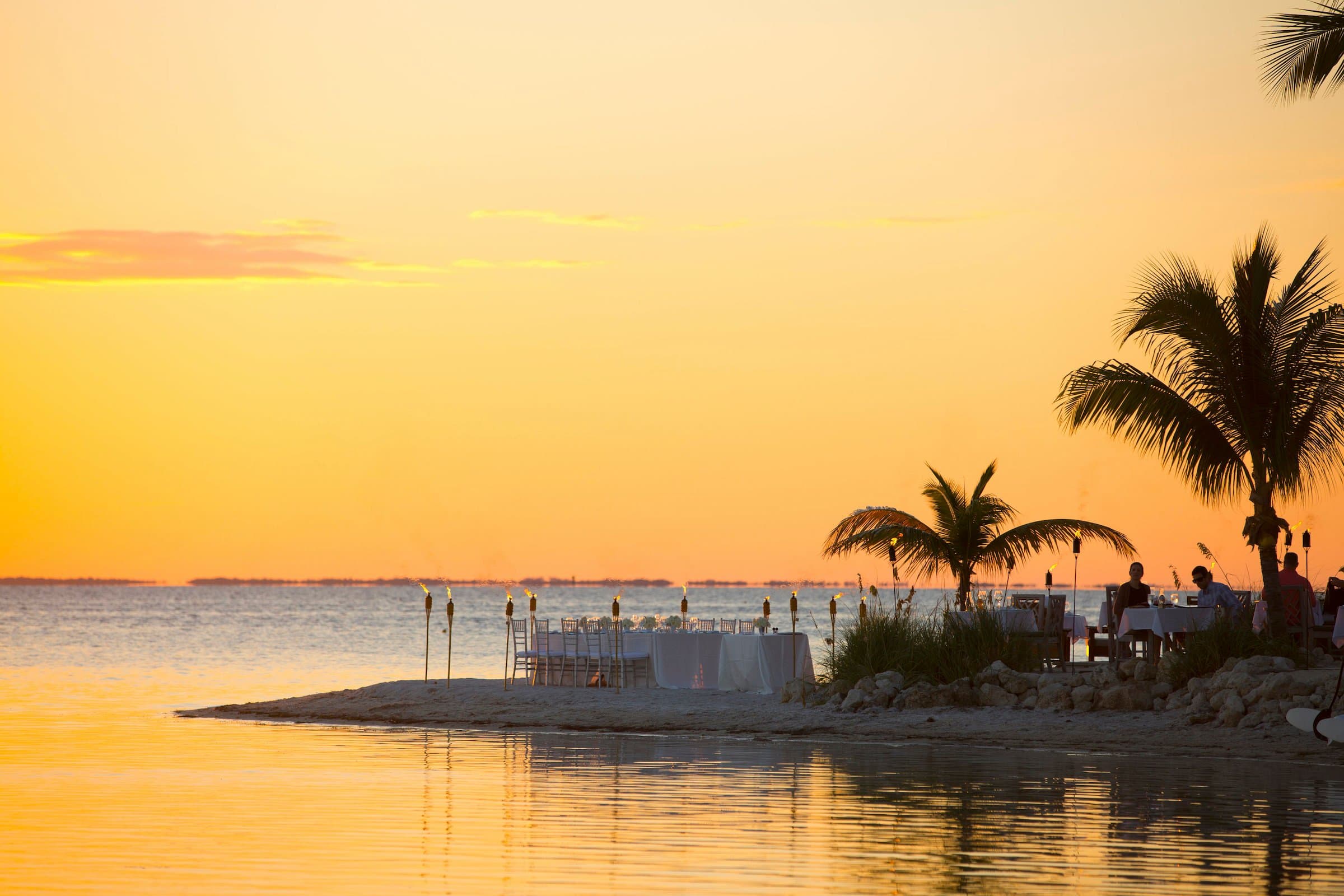 Tables set for a wedding on the beach in Little Palm Island