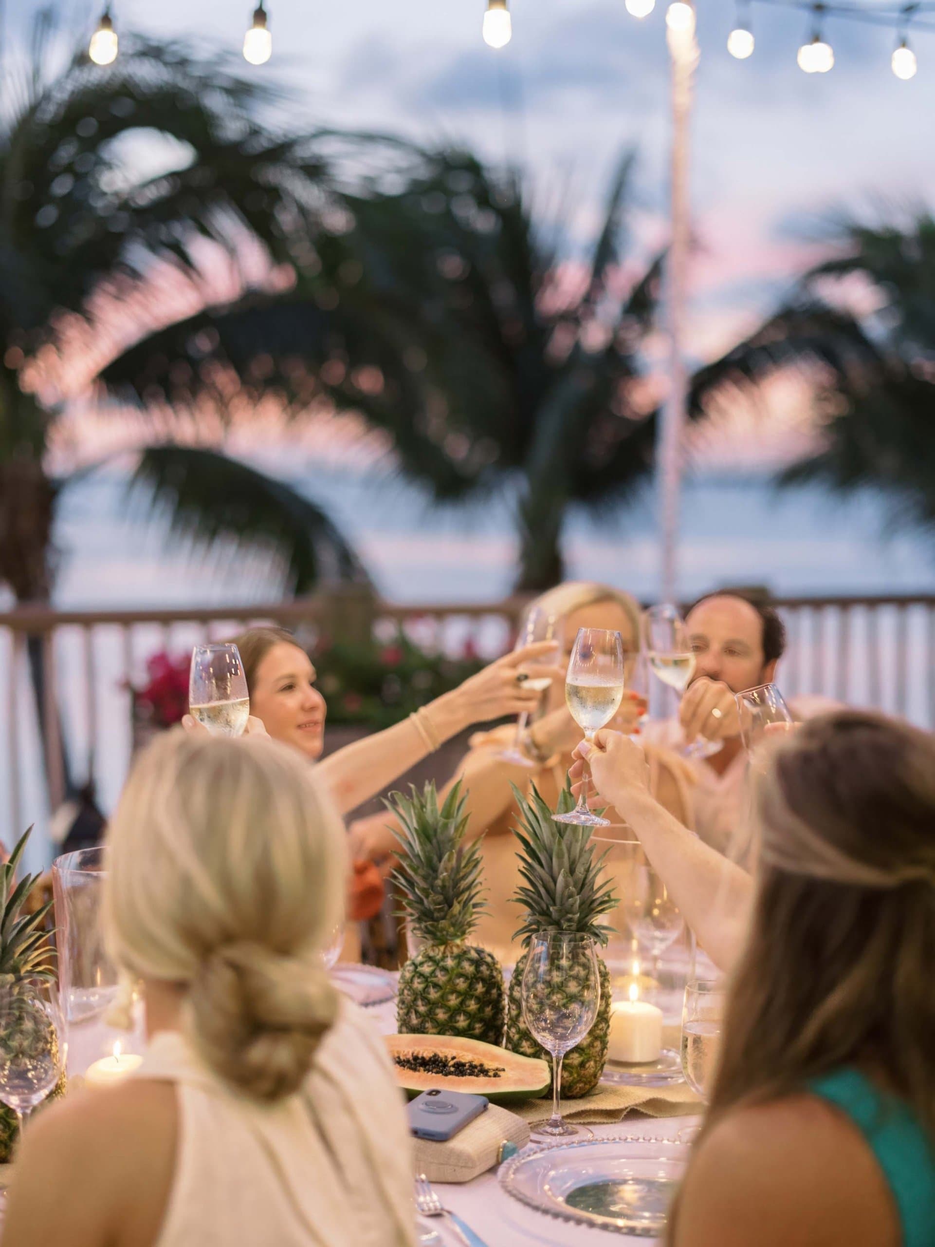 People dining together and clinking their glasses at a Noble House Hotels & Resorts property