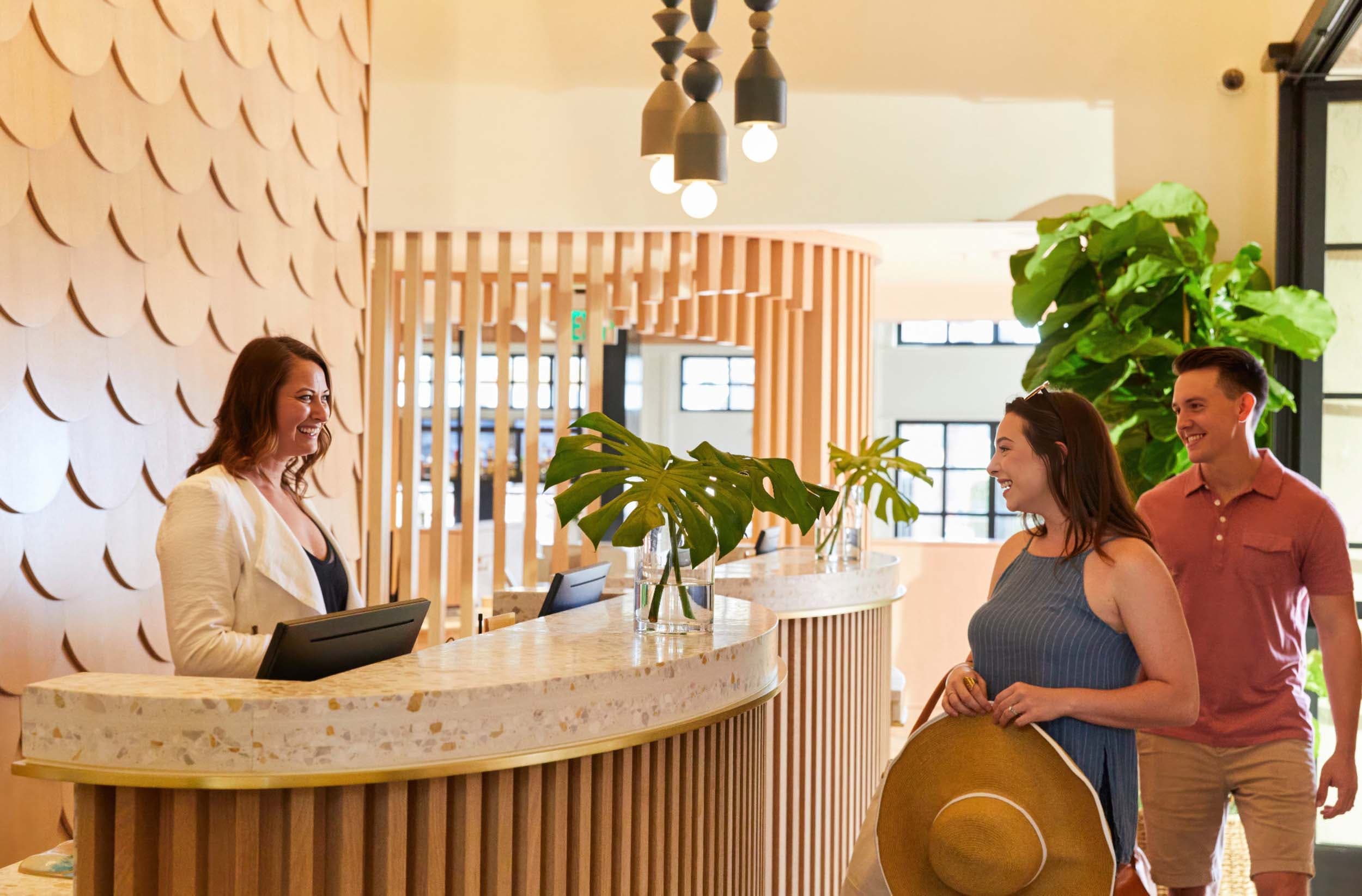 Couple checking into a Noble House Hotels & Resorts property