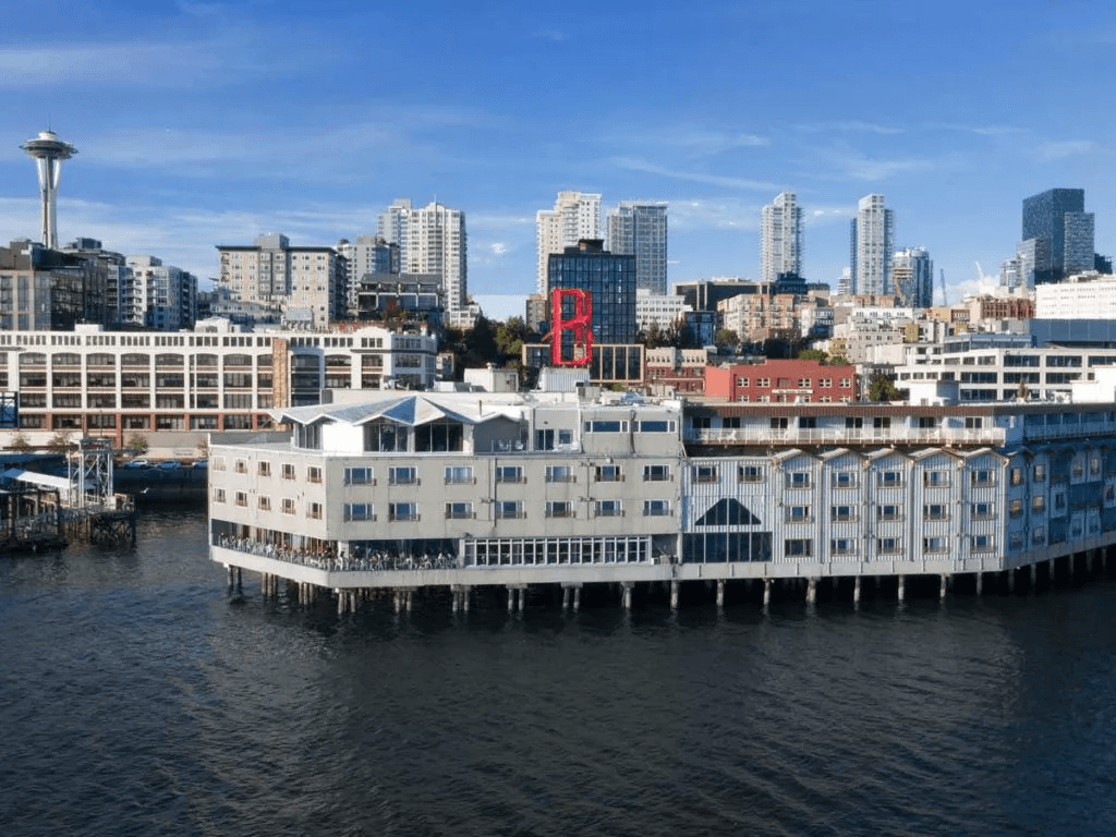 The exterior of the Edgewater Hotel against the city skyline
