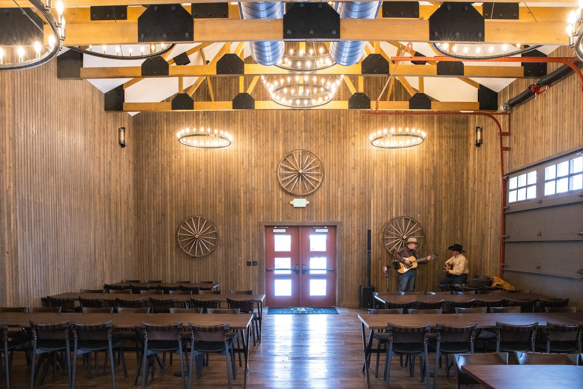 Two cowboys playing the guitar at the lodge barn in Snake River Sporting Club