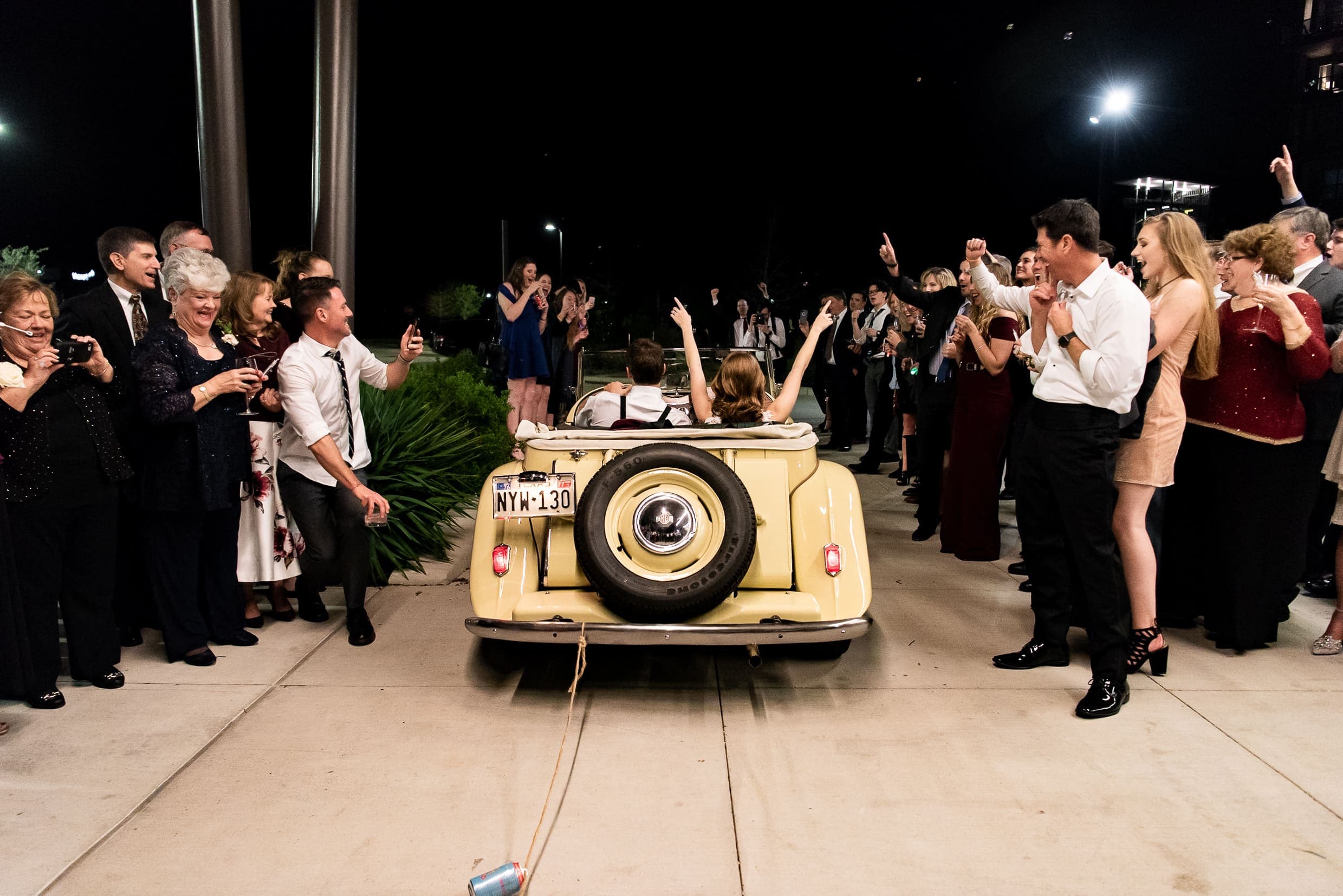 Married couple leaving their wedding in a vintage car at the Stella Hotel