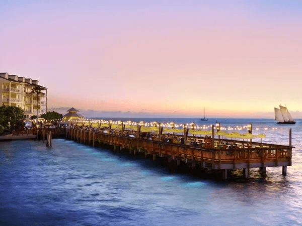 marina lit up at sunset at a Noble House Hotels & Resorts property