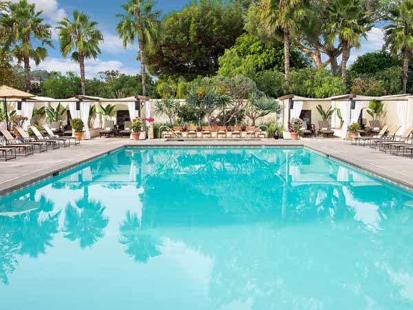outdoor pool and lounge chairs at a Noble House Hotels & Resorts property