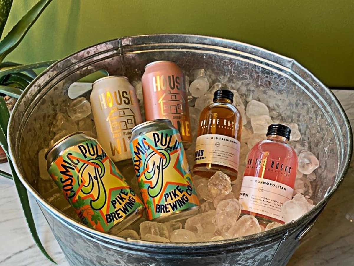 A metal bucket filled with ice and beverages, a Tropical Distancing™ -inspired “Can Do Attitude” welcome amenity